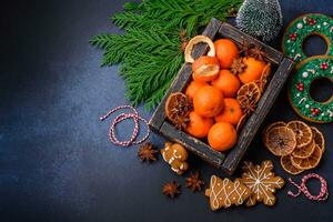 Beautiful festive Christmas composition of tangerines, gingerbread and star anise photo