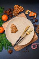 Beautiful festive Christmas composition of an empty plate, tangerine and gingerbreads photo