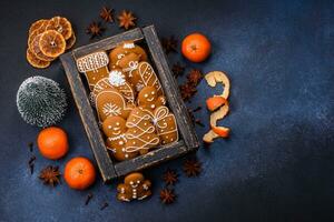 Beautiful festive Christmas composition of tangerines, gingerbread and star anise photo