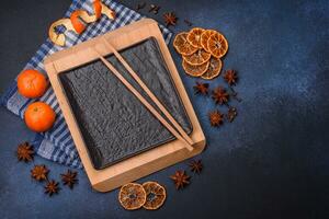 Beautiful festive Christmas composition of an empty plate, tangerine and gingerbreads photo