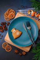 Beautiful festive Christmas composition of an empty plate, tangerine and gingerbreads photo