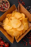 Crispy potato chips with salt, spices and herbs photo