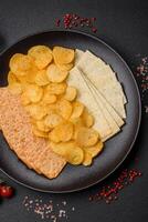 Crispy potato chips with salt, spices and herbs photo