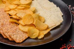 Crispy potato chips with salt, spices and herbs photo