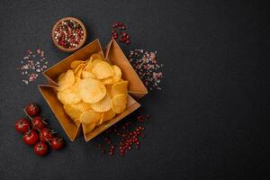 Crispy potato chips with salt, spices and herbs photo