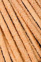 Delicious fresh grissini sticks with salt and sesame seeds photo