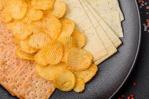 Crispy potato chips with salt, spices and herbs photo