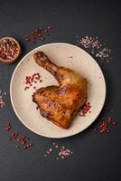 Delicious grilled chicken leg or quarter with salt and spices photo