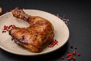 Delicious grilled chicken leg or quarter with salt and spices photo