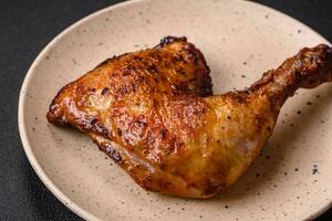 Delicious grilled chicken leg or quarter with salt and spices photo