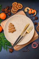 Beautiful festive Christmas composition of an empty plate, tangerine and gingerbreads photo
