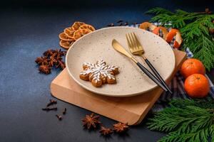 Beautiful festive Christmas composition of an empty plate, tangerine and gingerbreads photo