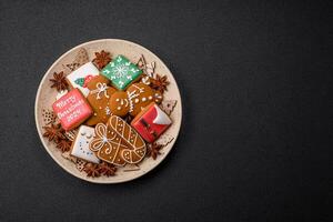 Beautiful Christmas gingerbread cookies of different colors on a ceramic plate photo