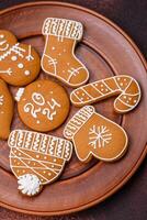 Beautiful Christmas gingerbread cookies of different colors on a ceramic plate photo