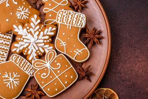 Beautiful Christmas gingerbread cookies of different colors on a ceramic plate photo