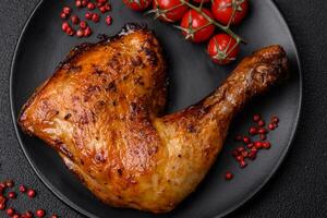 Delicious grilled chicken leg or quarter with salt and spices photo