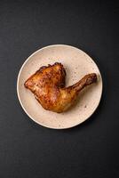 Delicious grilled chicken leg or quarter with salt and spices photo