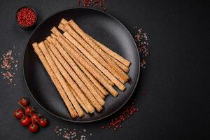 Delicious fresh grissini sticks with salt and sesame seeds photo