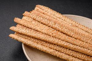 Delicious fresh grissini sticks with salt and sesame seeds photo