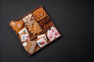 Beautiful Christmas gingerbread cookies of different colors on a ceramic plate photo