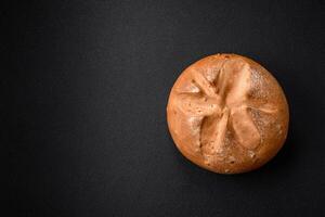 Delicious crispy aromatic fresh brown round bread with seeds and grains photo