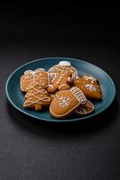 Beautiful Christmas gingerbread cookies of different colors on a ceramic plate photo