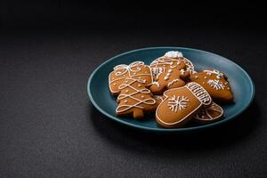 Beautiful Christmas gingerbread cookies of different colors on a ceramic plate photo