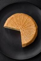 Delicious hard craft cheese made from cow or goat milk photo