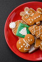 Beautiful Christmas gingerbread cookies of different colors on a ceramic plate photo