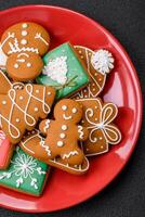 Beautiful Christmas gingerbread cookies of different colors on a ceramic plate photo