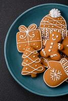 Beautiful Christmas gingerbread cookies of different colors on a ceramic plate photo