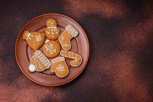 Beautiful Christmas gingerbread cookies of different colors on a ceramic plate photo