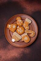 Beautiful Christmas gingerbread cookies of different colors on a ceramic plate photo