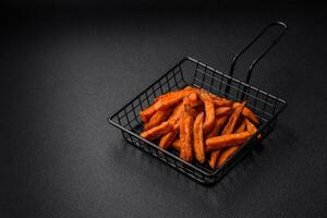 Delicious crispy sweet potato fries with salt, spices and herbs photo