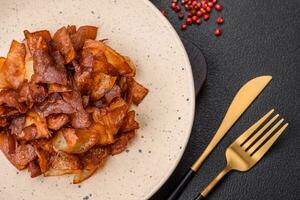 Delicious crispy potato chips with salt and spices photo