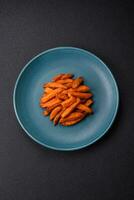 Delicious crispy sweet potato fries with salt, spices and herbs photo