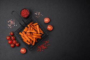 Delicious crispy sweet potato fries with salt, spices and herbs photo