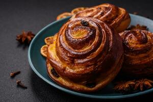 Delicious baked cinnamon raisin rolls in the form of rolls photo