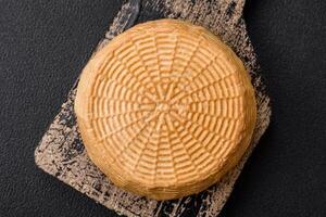 Delicious hard craft cheese made from cow or goat milk photo