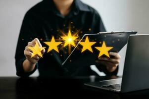 Customer or client the stars to complete five stars. with copy space. giving a five star rating. photo