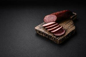 Delicious smoked sausage with salt and spices cut into slices photo