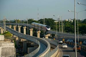 Bangkok, Thailand-November 21, 2023- Sky train of metropolitan rapid transit pink line arriving at Wat Phra Sri Mahathat station. photo