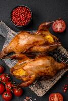 Roasted quail, partridge or pigeon stuffed with orange with spices and herbs photo