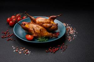 Roasted quail, partridge or pigeon stuffed with orange with spices and herbs photo