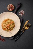 Delicious Uzbek pilaf with chicken, carrots, barberry, spices and herbs photo