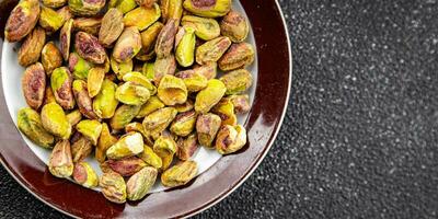 pistachos pelado sin cáscara nuez sano comiendo Cocinando aperitivo comida comida bocadillo en el mesa foto