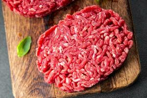 ground meat raw cutlet fresh beef meat hamburger eating cooking appetizer meal food snack on the table copy space food background rustic top view photo