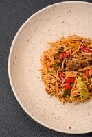 delicioso udon tallarines con carne o mariscos, verduras, sal y especias foto