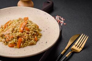 Delicious Uzbek pilaf with chicken, carrots, barberry, spices and herbs photo