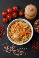 Delicious Uzbek pilaf with chicken, carrots, barberry, spices and herbs photo